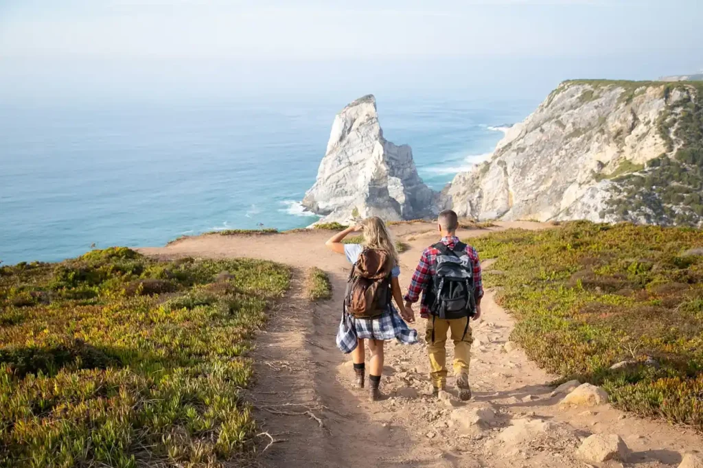 Hikers on a coastal trail with ocean views, ideal inspiration for hiking in the BVI.