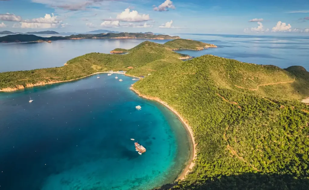 Aerial view of Norman Island with rugged coastline and turquoise waters, a highlight for snorkeling in the BVI.