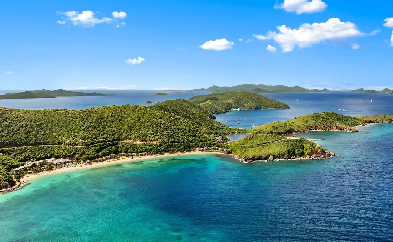 Aerial view of Peter Island surrounded by turquoise waters, highlighting BVI Private Island resorts