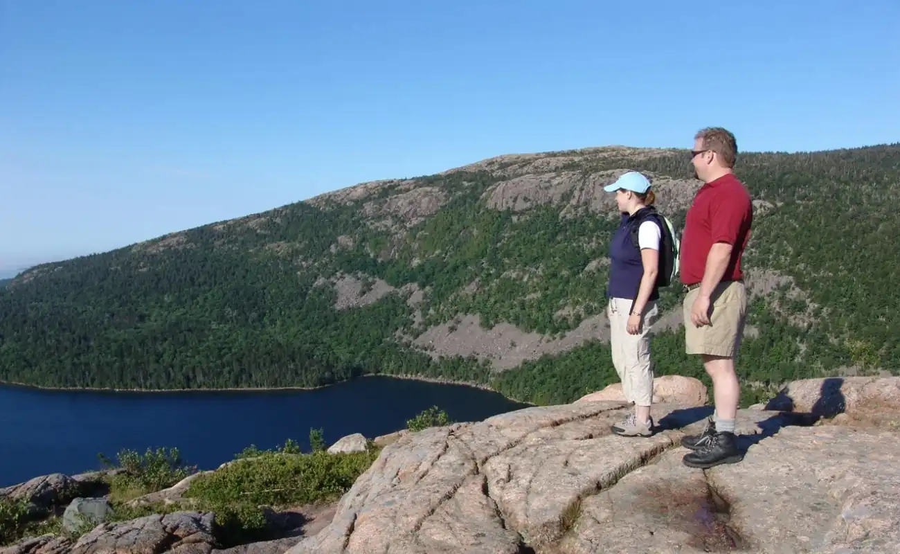 Couple hiking along a scenic trail with ocean views during BVI outdoor adventures.