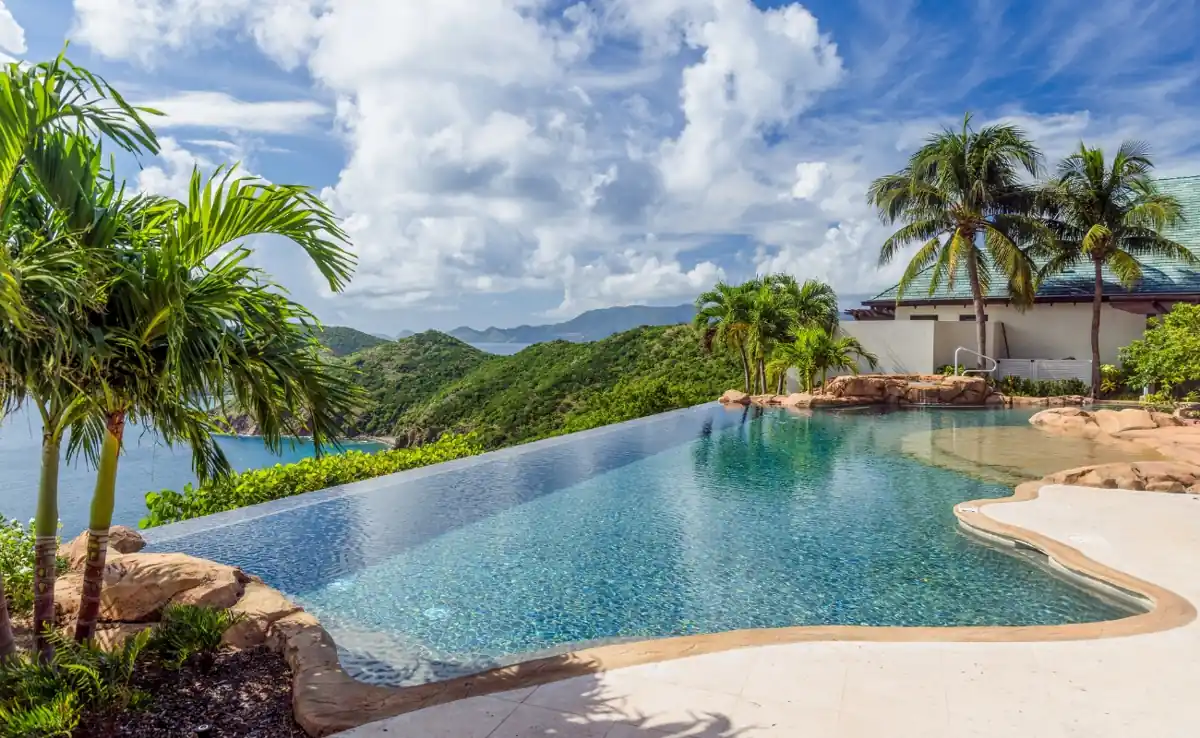 Infinity pool overlooking turquoise waters at a luxury retreat among private island resorts in the BVI.