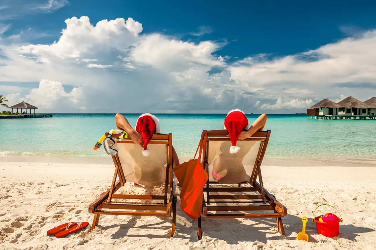 Travelers relaxing on the beach during a Christmas in July BVI vacation