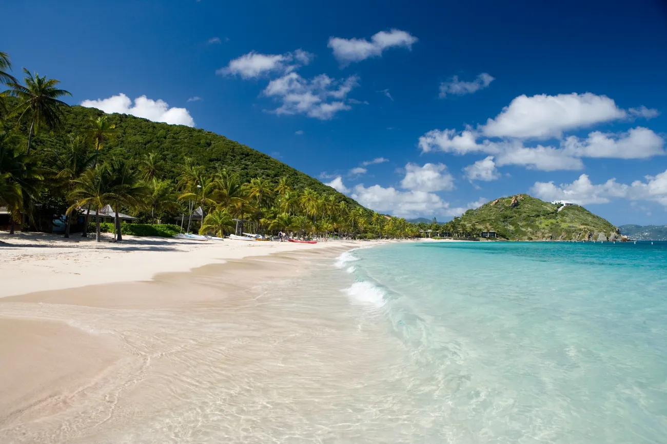 Palm-lined Deadman's Beach at Peter Island, a leading BVI private island resort